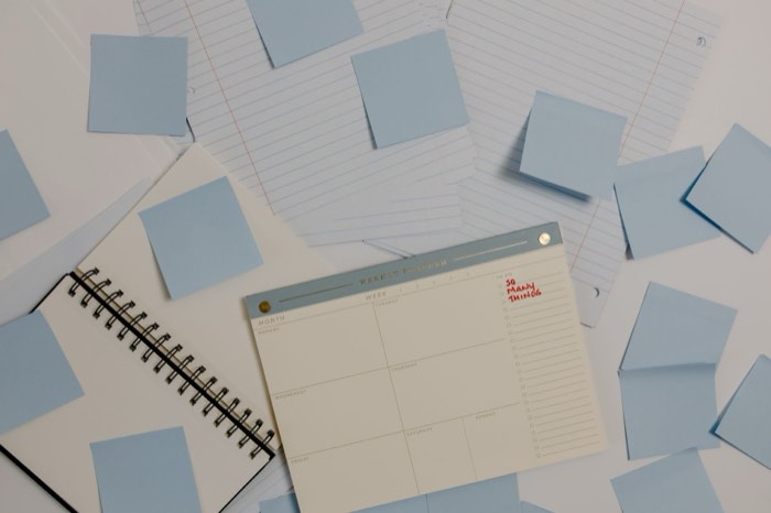A planner and sticky notes on a desk