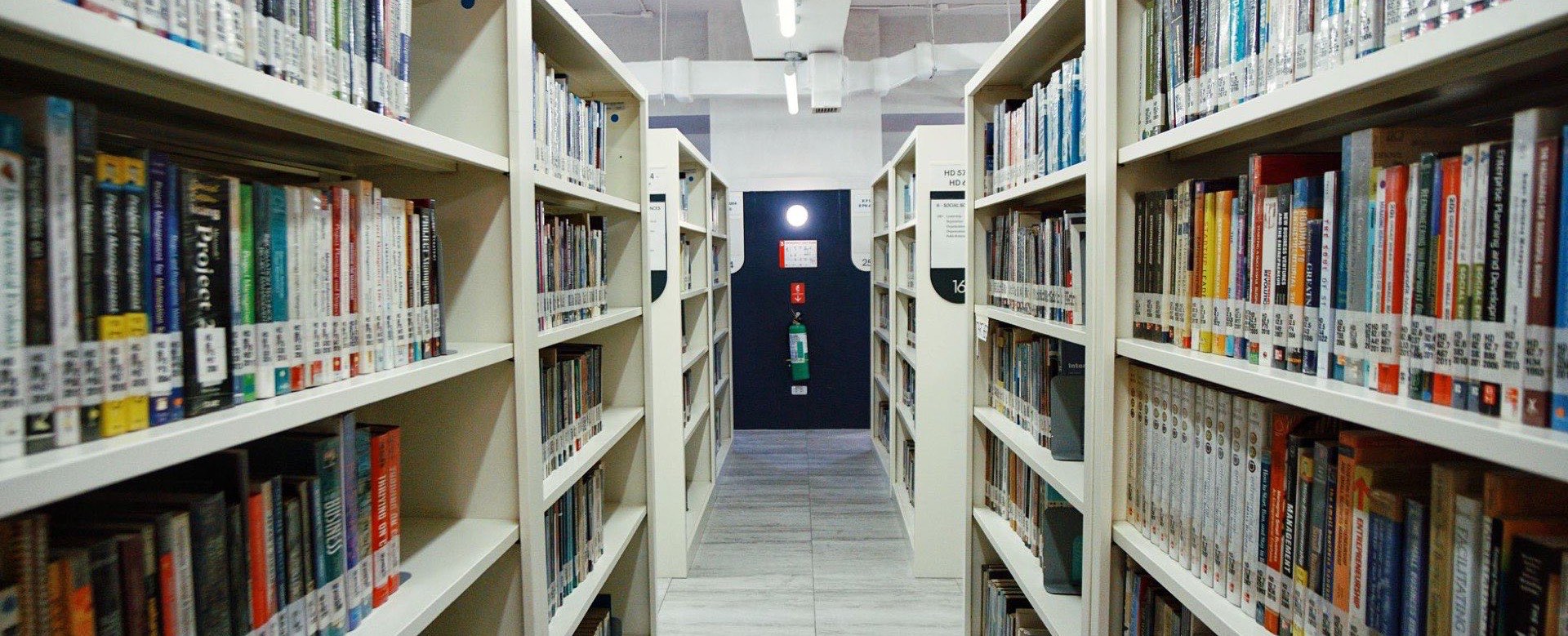 A corridor between library shelves
